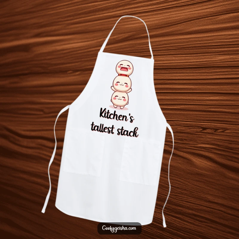 Funny apron design showing a character humorously trying to balance a large stack of Daruma dolls, perfect for a kitchen laugh.