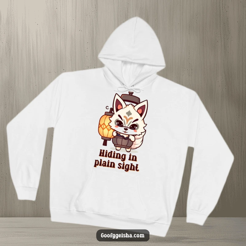 Funny cozy hoodie featuring a cute Kitsune masked character playfully peeking from behind a lantern, adding mystery.