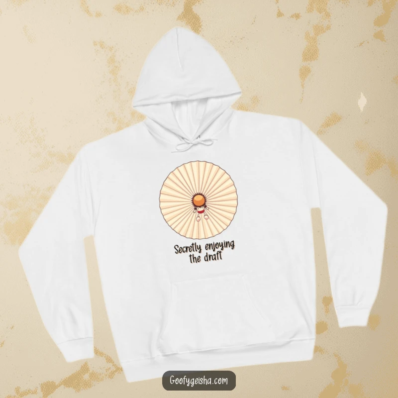 Funny hoodie with a small character hiding behind a massive, smiling fan, enjoying the cool air. Ideal for cozy humor and warmth.