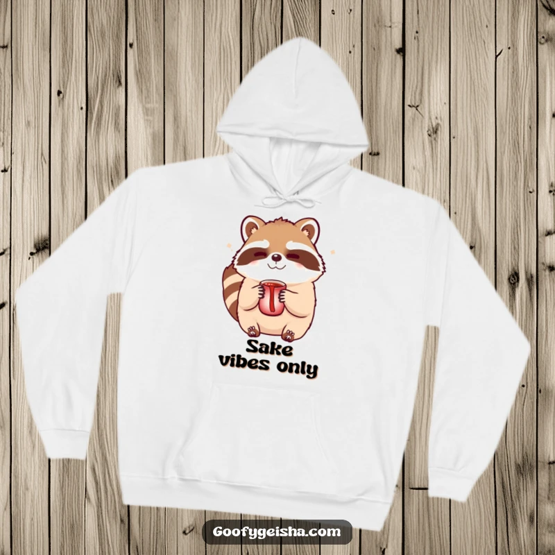 Funny Tanuki hoodie featuring a cute character winking suggestively while holding a sake cup, perfect for cozy, playful vibes.