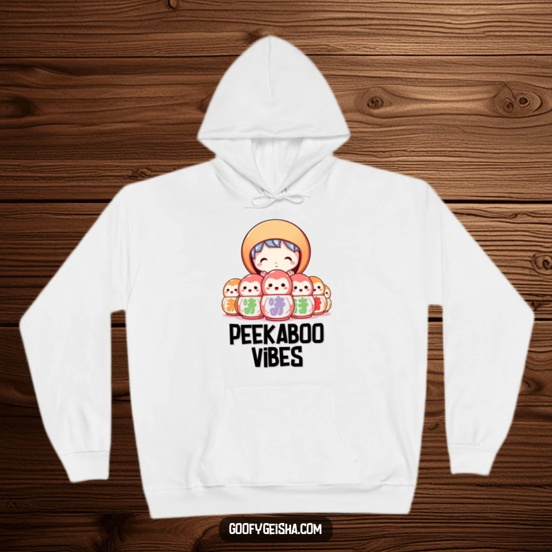 Funny hoodie featuring a character peeking curiously from behind a stack of colorful daruma dolls. Cozy and mysterious.